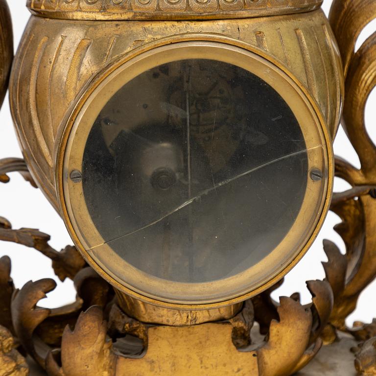 A grand mantle piece set with a clock and a pair of candelabras, Louis XV-style, second half of the 19th century.