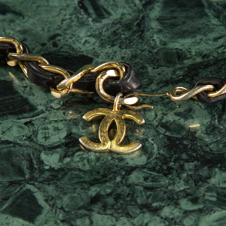 Belt with mini flap-bag by Chanel.