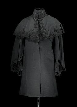 1518. A late 19th cent black wool coat.