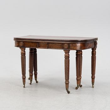 A regency mahogany dining table with four additional leaves.