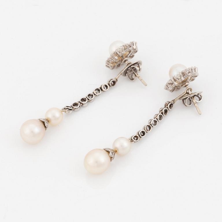 A pair of 18K white gold and cultured bouton pearl earrings set with round brilliant-cut diamonds.