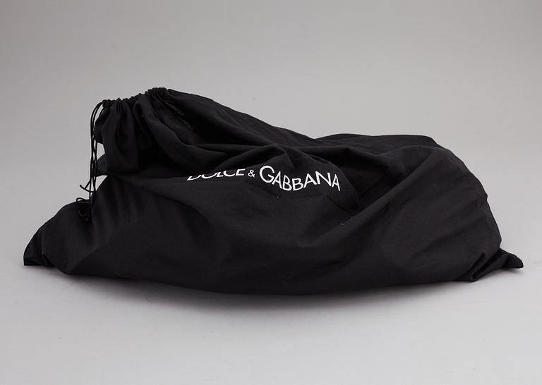 DOLCE & GABBANA, a black leather weekend bag, 2009.