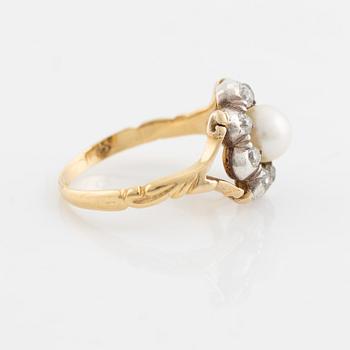 An 18K gold ring and silver set with a pearl and old-cut diamonds.