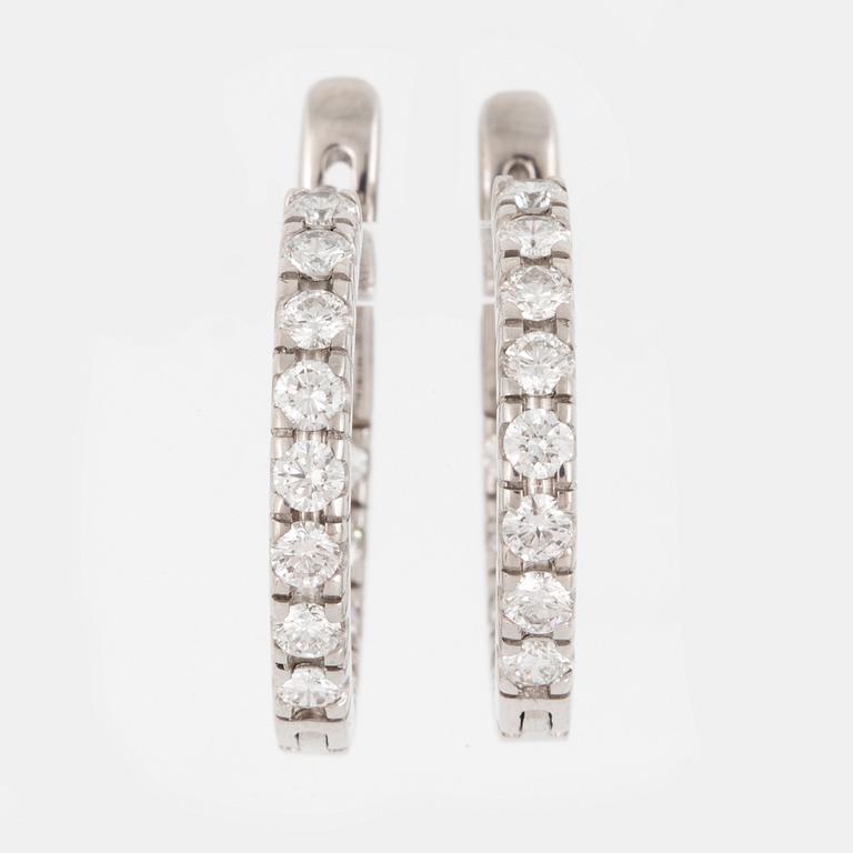 A pair of diamond earrings.