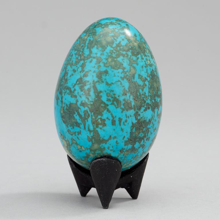 A Hans Hedberg faience egg on an iron base, Biot, France.