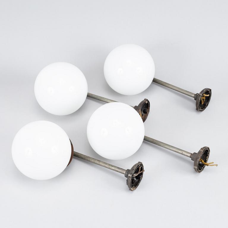 A set of four metal wall lights, first half of the 20th century.