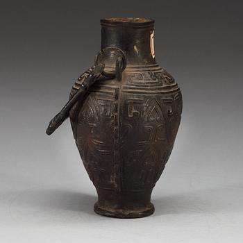 An archaistic bronze vase with a handle, presumably Ming dynasty.