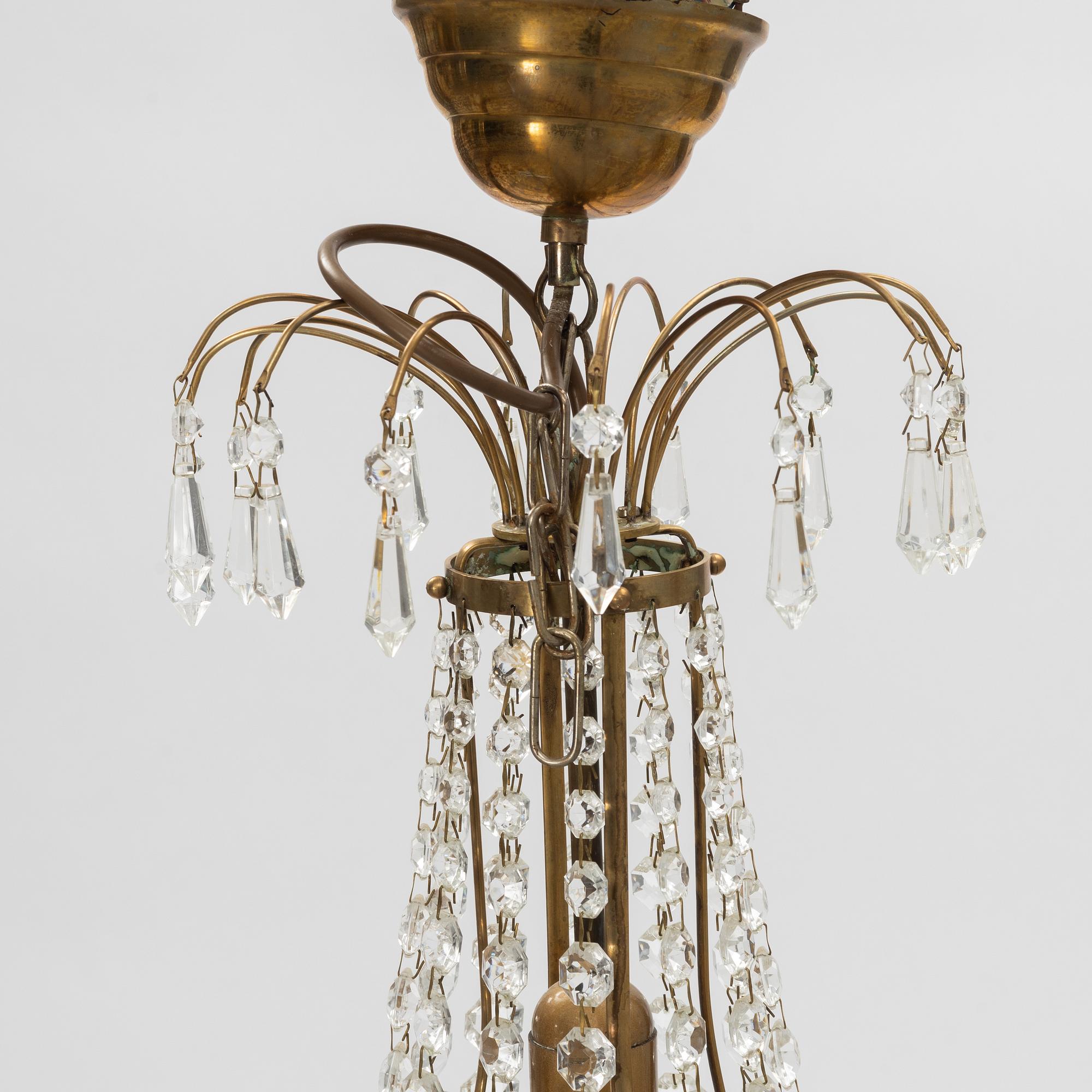 A contemporary matched pair of chandeliers for four candles each.