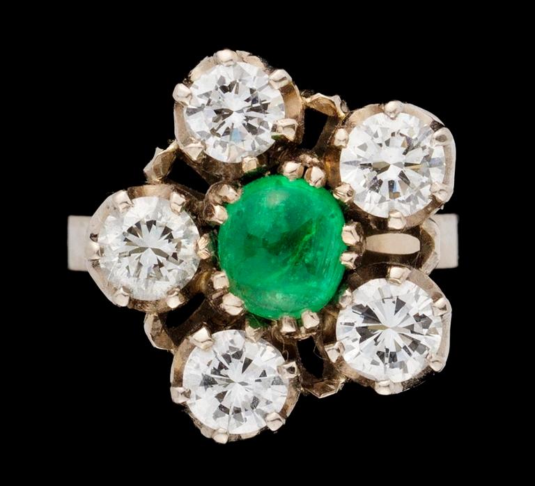 A gold, emerald and diamond ring.