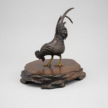 A Japanese bronze sculpture or okimono in the shape of a rooster, Meiji (1868-1912).