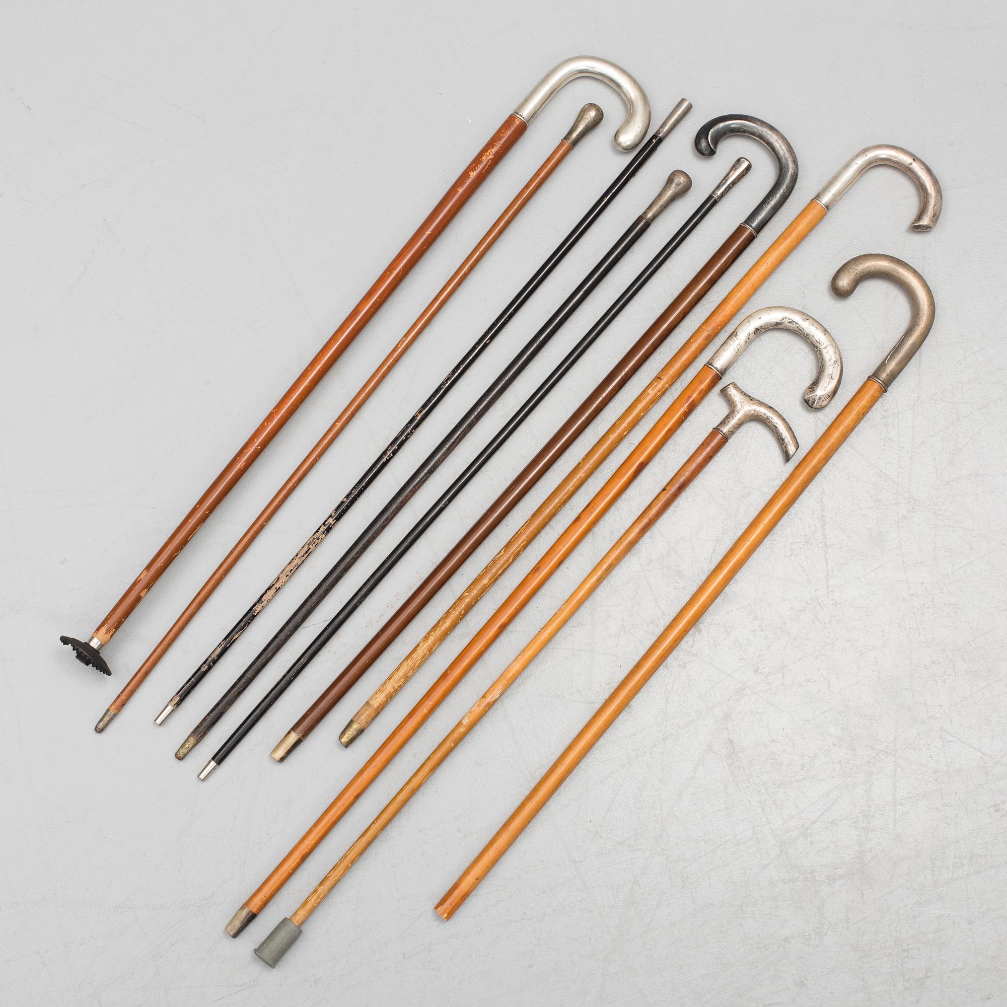 NINE WALKING STICKS, silver handles and a stick with plate handle, first half of the 20th century.