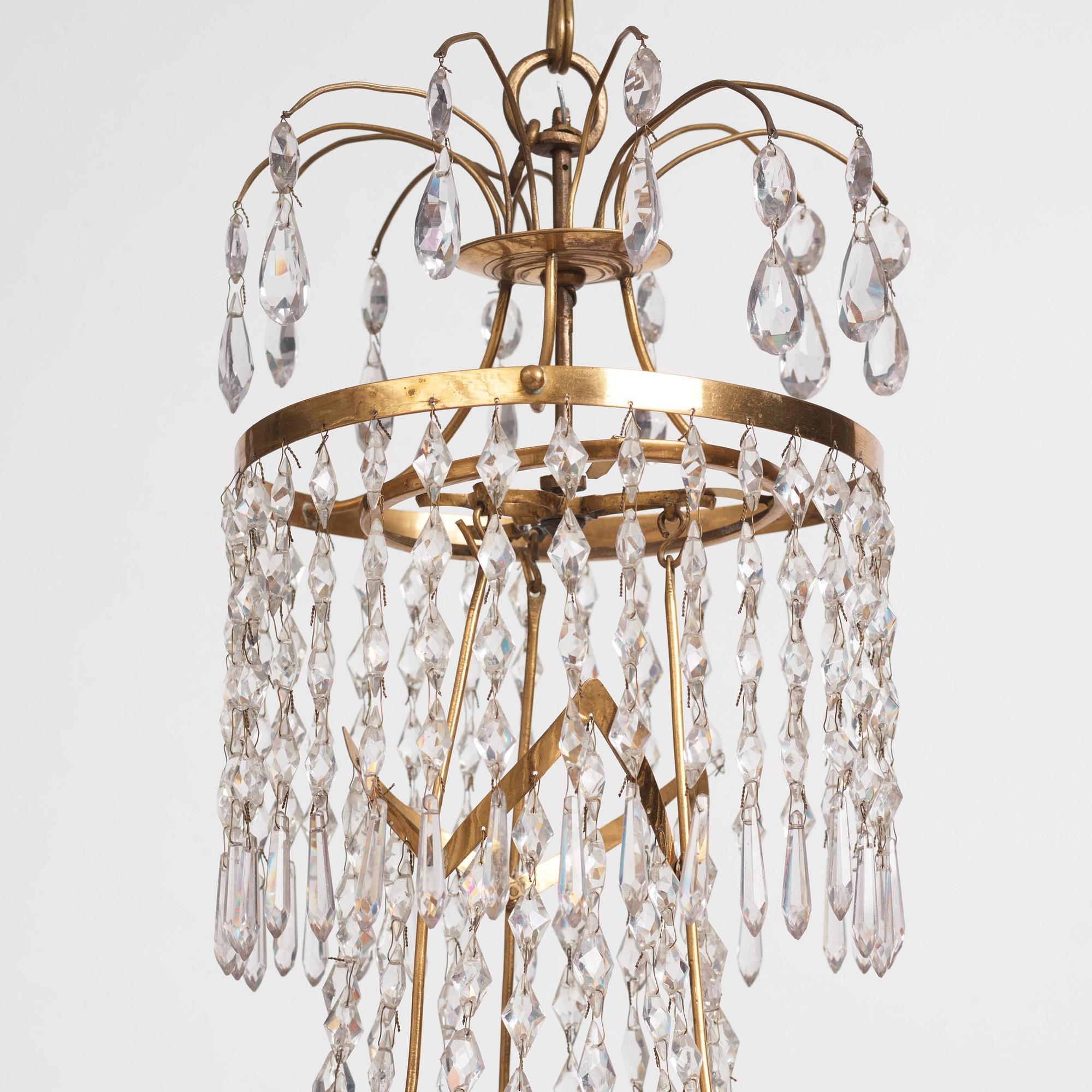 A late Gustavian gilt brass and cut glass seven-branch chandelier, Stockholm, late 18th century.