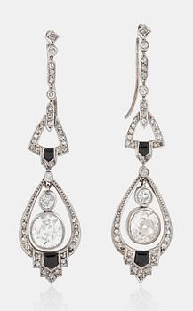 1127. A pair of old-cut diamond and onyx earrings. Total carat weight circa 4.70 cts.