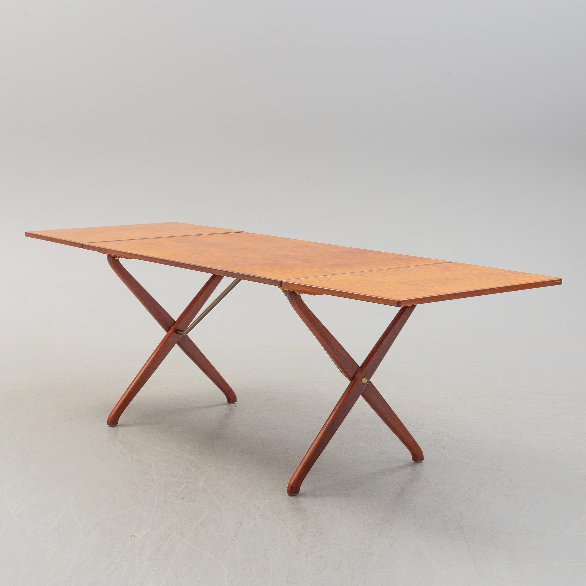 A teak veneer and stained beech dining table, mid 20th Century.