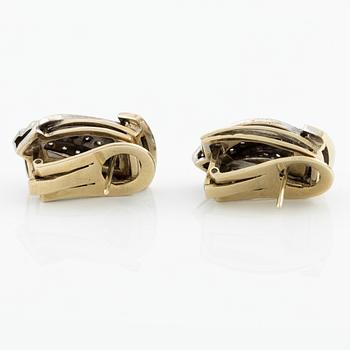 Gold earrings with brilliant-cut and octagon-cut diamonds.