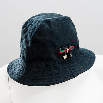 GUCCI, CAMEL HAIR PONCHO AND A HAT.