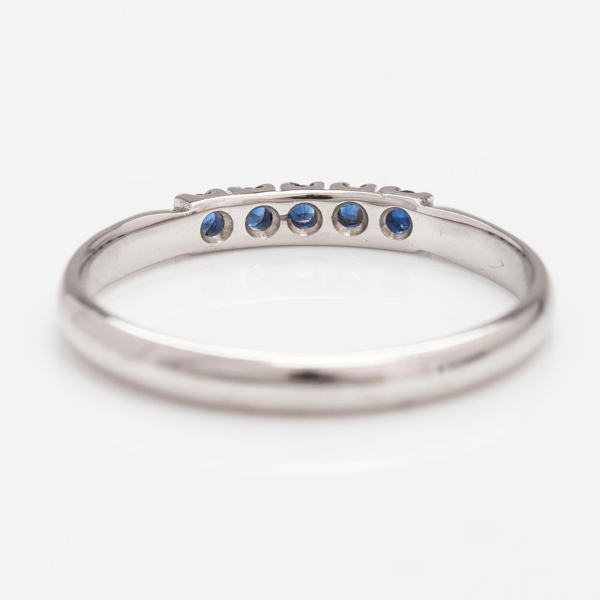 A 14K white gold ring with sapphires.