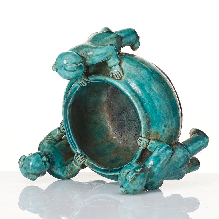 A turquoise glazed vessel supported by a group of boys, Qing dynasty, Kangxi (1662-1722).