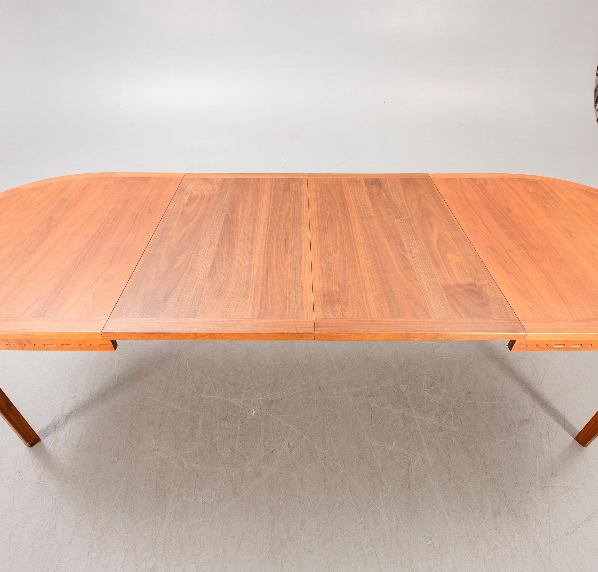 A Nils Jonsson teak and walnut 1960s dining table.