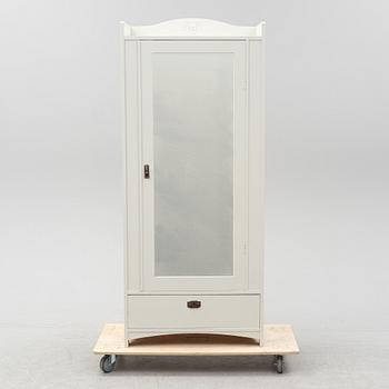 An early 20th Century painted clothes cabinet.