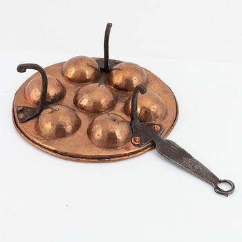 Four cake moulds, and a funnel, copper, 18th and 19th Century.