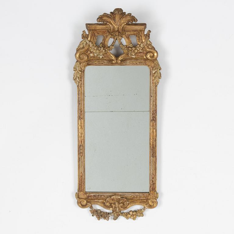 A Gustavian carved giltwood mirror, Stockholm, late 18th century.