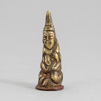 193. A Tibetan gilt copper alloy weight, 16th Century or older.