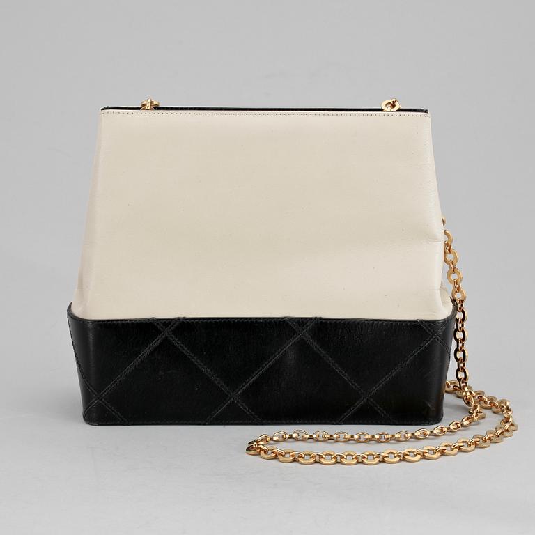 A black and white leather shoulder bag by Salvatore Ferragamo.