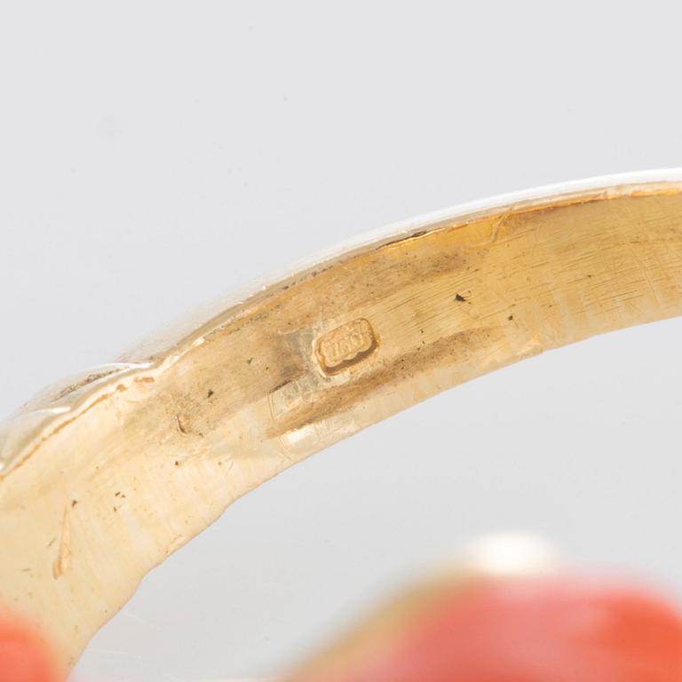 A ring in carved coral in the form of a ram's head.