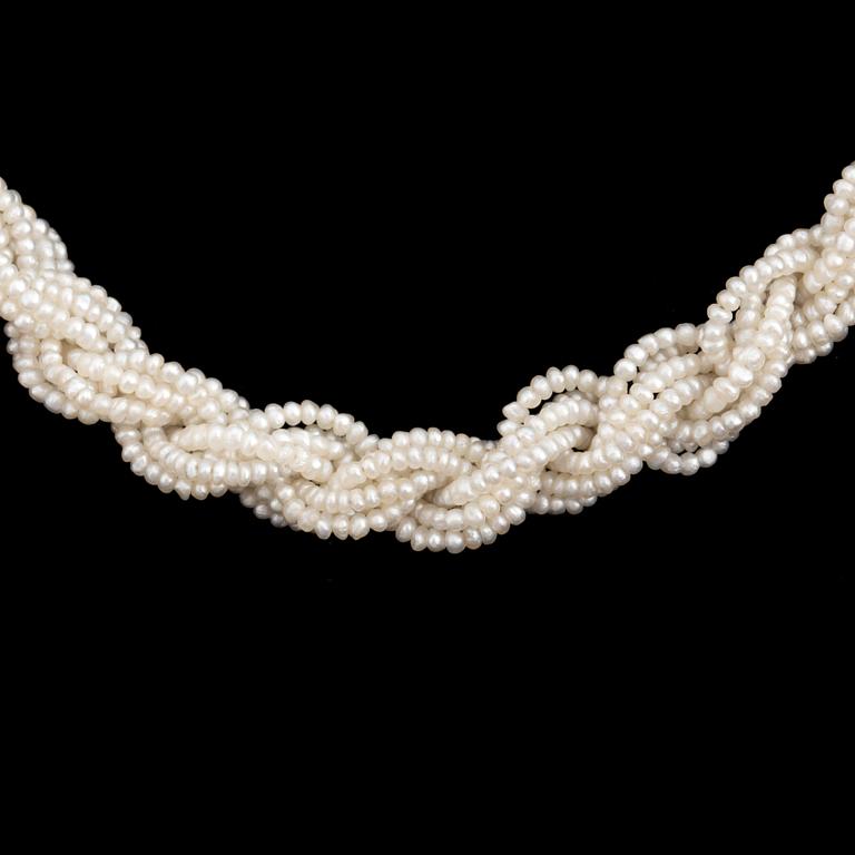 A necklace of cultured pearls and seed pearls with a silver clasp decorated with probably synthetic rubies.