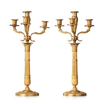 84. A pair of Empire early 19th century gilt bronze four-light candelabra.