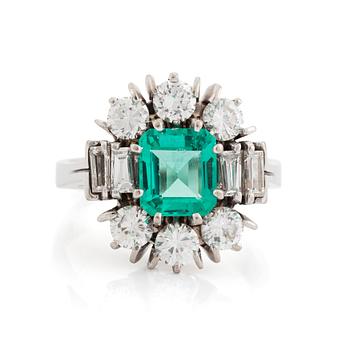 471. An 18K white gold ring set with a step-cut emerald.