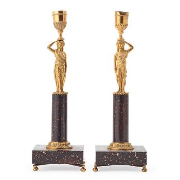 58. A pair of late gustavian early 19th century porphyry and ormolu candlesticks.