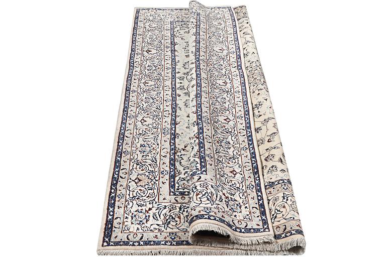 A Nain carpet, part silk, c. 294 x 193 cm.