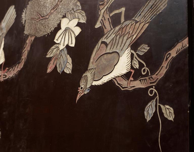 A coromandel black-lacquer four panel screen, Qing Dynasty (1644-1912).