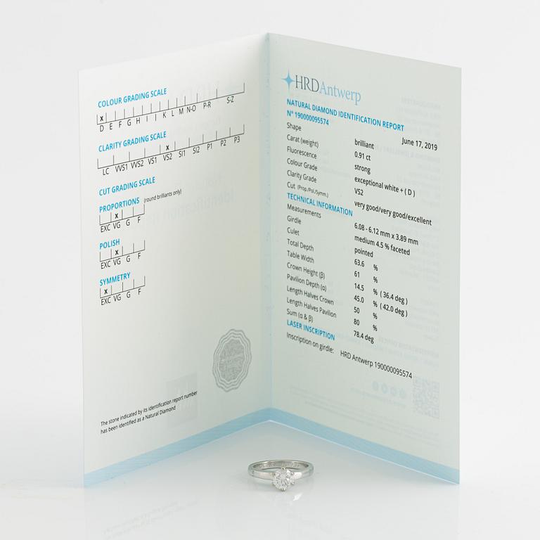 An 18K white gold ring set with a round brilliant-cut diamond.