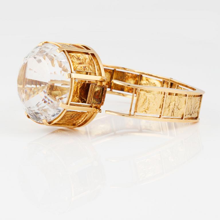 ARMRING, 18K guld med fasettslipad bergkristall, Bengt Rehnvall, Stockholm, 1965. Vikt 62,9 gram.