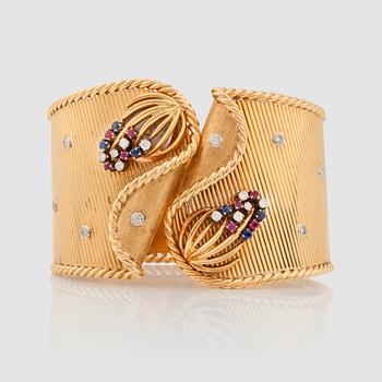 1203. A Gübelin ruby, sapphire and brilliant-cut diamond bracelet with a hidden watch.