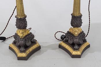 A pair of bronze late 19th/ early 20th century table lamps.