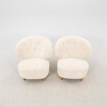 A pair of Scandinavian Modern 1940s cheepskin armchairs.