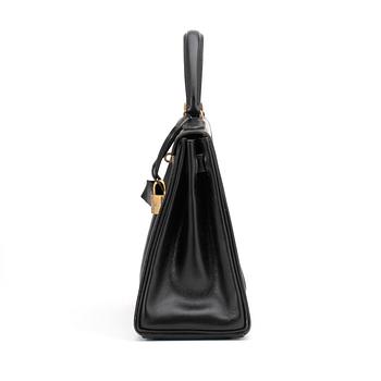 HERMÈS, a black leather bag, "Kelly 28".