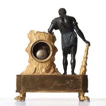 An Empire early 19th Century gilt and patinated bronze mantel clock marked by Devaulx a Paris.