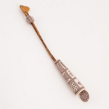 An engraved reindeer needle case.