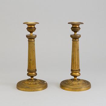 A pair of French gilt bronze Empire candlesticks, first half of the 19th Century.