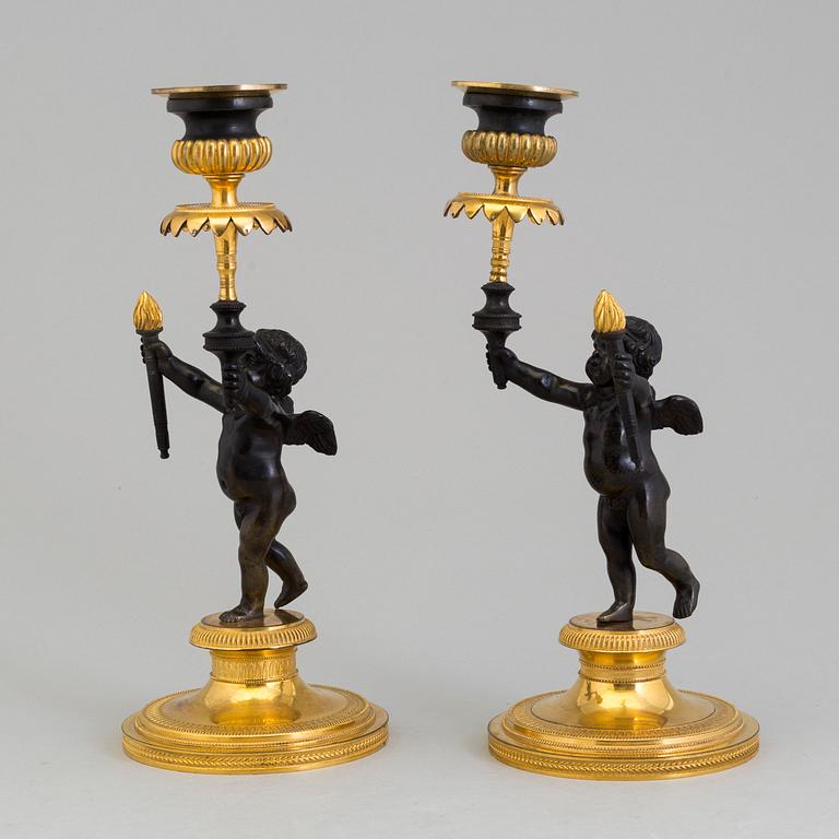A pair of late 19th century, gilded bronze, Empire style, candle sticks.