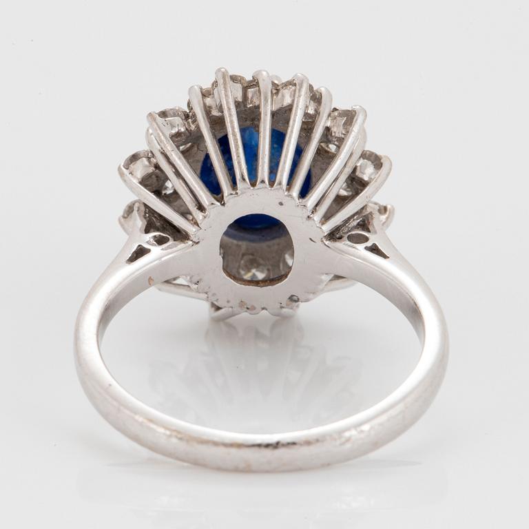 An 18K white gold ring set with a cabochon-cut sapphire ca 4.00 cts and round brilliant-cut diamonds.