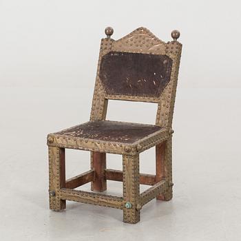 An Ashanti chair, Ghana, hardwood with brass studs, ca 1900.