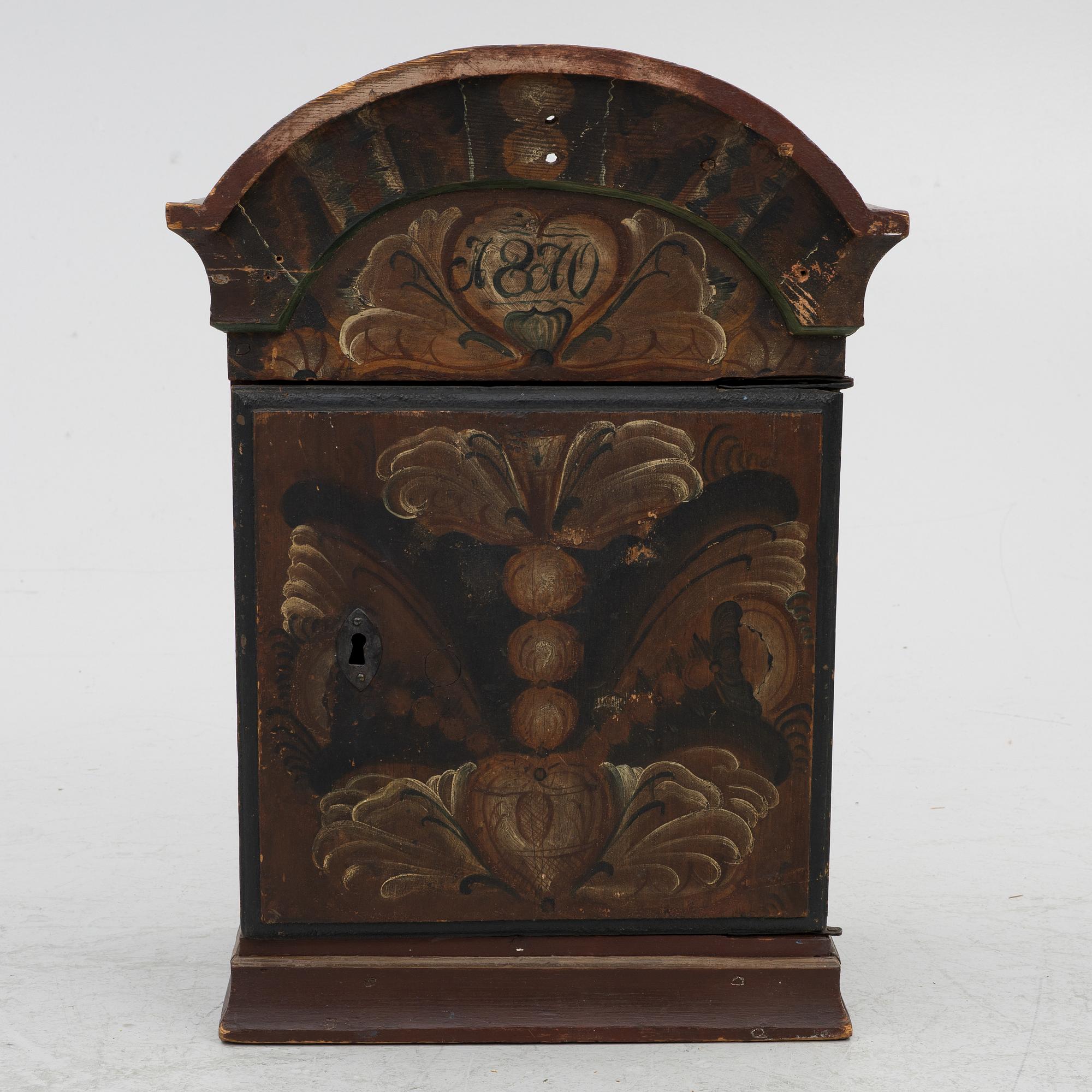 A hanging cabinet, dated 1870.