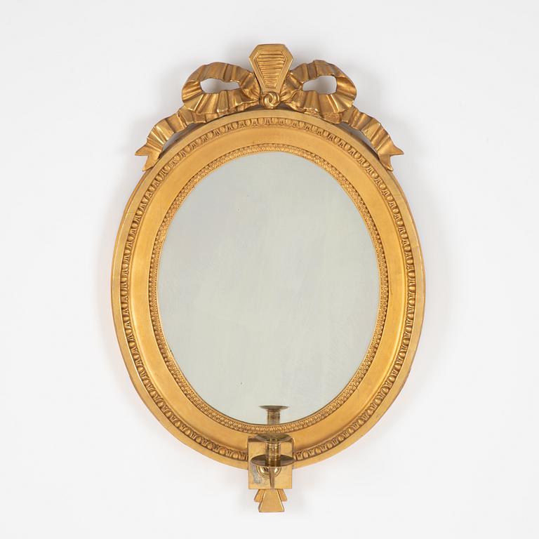 A Gustavian giltwood one-branch girandole mirror, Stockholm, late 18th century.