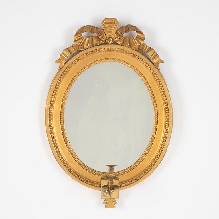 A Gustavian giltwood one-branch girandole mirror, Stockholm, late 18th century.